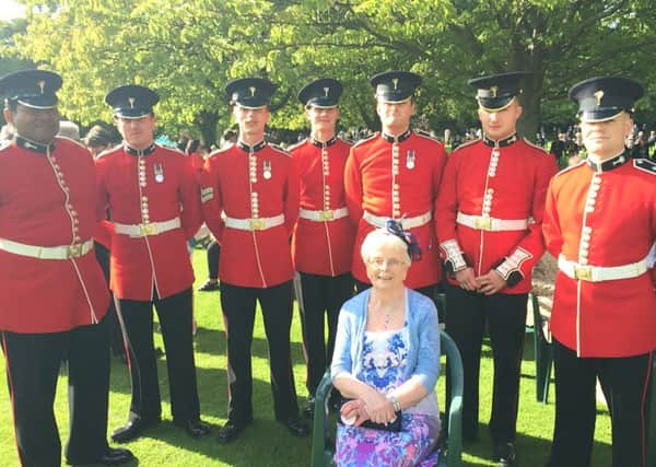 Mrs May Lappin with the Queens Bandsmen at the Royal Garden Party at Buckingham Palace .