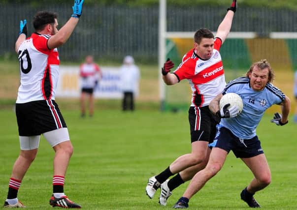 Cookstown's Owen Mulligan is hustled for the ball