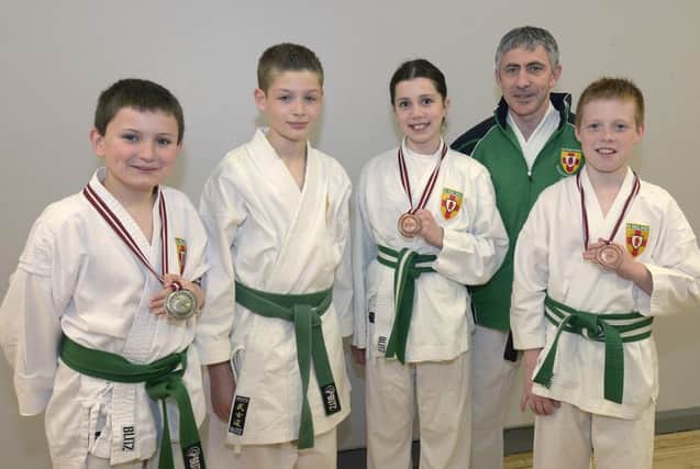 Dromore Karate Club Coach Liam Haslem with WKC World Championship competitors  Reece Robinson, Christopher Cassells, Courtney Haslem and Bradley Montgomery ©Edward Byrne Photography INBL1522-204EB