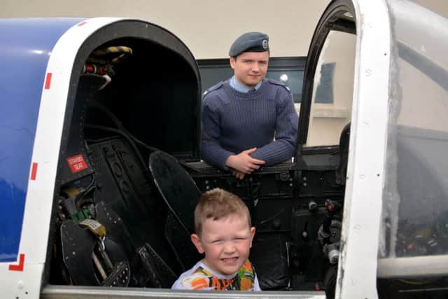 James Waite is shown the inside of a jet cockpit by Cpl Luke Crymble from Carrick 2062 Squadron ATC at Victoria Primary School's summer fete. INCT 22-019-GR