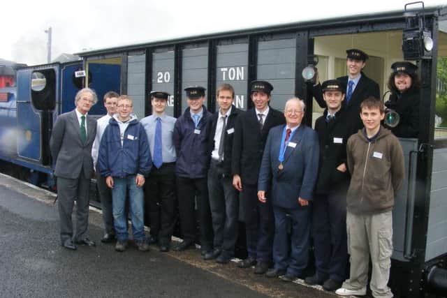 Lord O'Neill with a group of RPSI volunteers who worked on the restoration of Ivan, the Great Northern brake van. INCT 21-726-CON