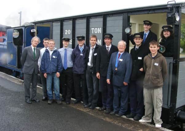 Lord O'Neill with a group of RPSI volunteers who worked on the restoration of Ivan, the Great Northern brake van.  INCT 21-726-CON