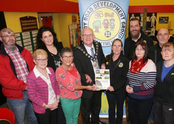 Mayor of Mid and East Antrim Council, Cllr. Billy Ashe, is pictured with members of the Doury Road Development Group at the launch of their new brochure celebrating the achievements of the group. INBT23-227AC