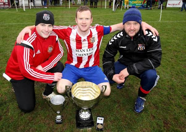 Ballymacash captain Philip Crowe (centre) with team manager Willie Johnston and coach Davy Waterworth after the Boxing Day victory against Warren YM in the Ironside Cup final at Stanley Park. US1452-546cd  Picture: Cliff Donaldson