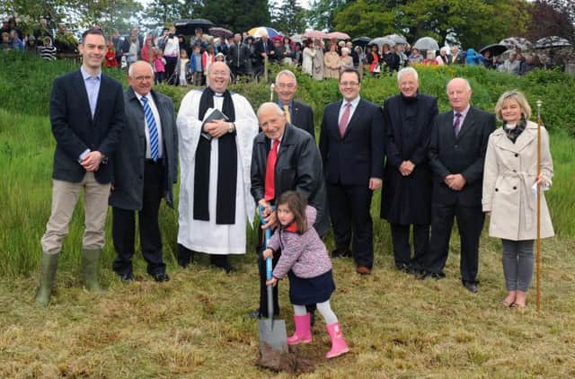 The congregation looks on as Bill Parkes and Rachel Price turn the first sod for a new Parish Hall Building at St Patricks Parish Church, Drumbeg following morning worship on Sunday 31st May.  L to R: Ryan Price, Hugh Crookshanks (Rectors Glebewarden), Rev Willie Nixon (Rector), Michael Barnett (Rectors Warden), Councillor Alexander Redpath (Deputy Mayor of Lisburn & Castlereagh City Council),Clyde Markwell (Architect), Mark Crowe (Building Contractor) and Candida Corscadden (Peoples Warden).  Bill Parkes is the most senior member of the congregation and Rachel Price is the youngest member of the Sunday School.
