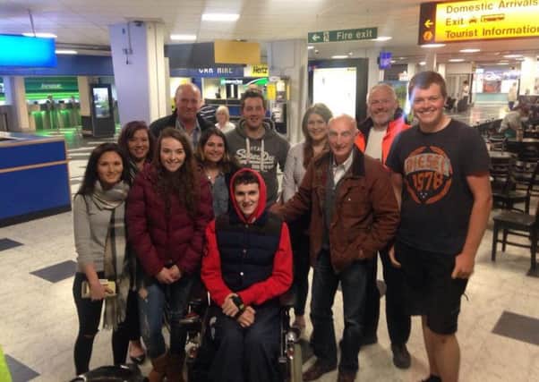 David Stanbridge (far right) receives a surprise welcome home from family and friends including Jonjo Bright (front centre) after his return from France. INLT-22-717-con