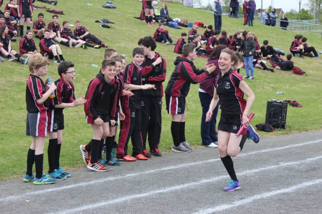 Year 8 student Erin Maguire crosses the line as her team wins the relay race. INCT 22-772-CON