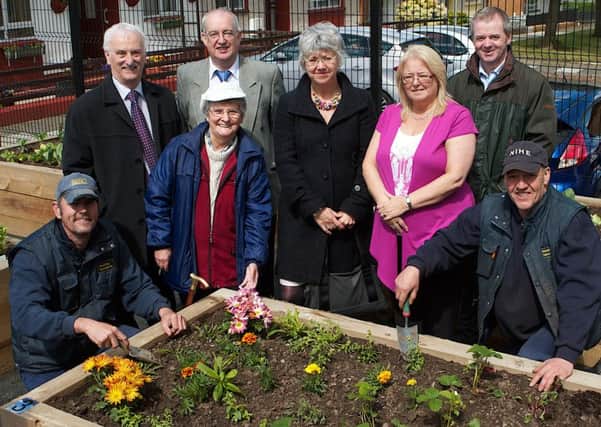 Masie Crawford at her growing space with Mark Hunter and Rolf Hamilton from the Housing Executive, Cllr Drew Thompson, Chairman of Caw/Nelson Drive Action group, Stephen Stewart, Avril McAlister, Area Manager, Linda Watson and Stephen Proctor, Housing Executive. Photo: Tom Heaney, nwpresspics