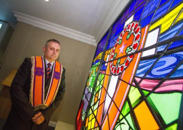 Colin Campbell, a member of the  Institution's murdered brethren committee, beside the commemorative stained glass window at  new Museum of Orange Heritage in Belfast. Photo: Graham Curry Photography