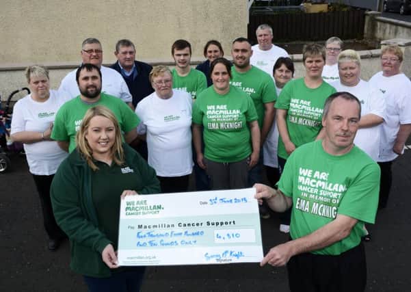 Garry McKnight pictured handing over a cheque for £4,810.00, proceeds of a sponsored walk from the Waterside Railway station at Duke Street to Donemana in memory of Elma McKnight, to Emma Ewings, Fundraising Manager for Macmillan Cancer Support. Included are some of the friends and family of Elma who supported the event. INLS2315-104KM