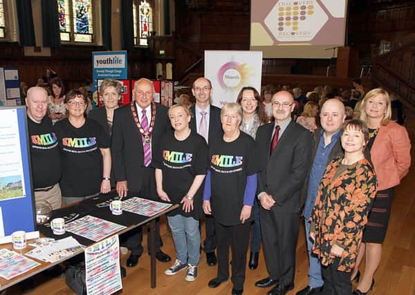 The Deputy Mayor Alderman Thomas Kerrigans, who officially opened the Mental Health Recovery Services Awareness event in the Guildhall, pictured with Western Health and Social Services Trust representatives at the Supporting Mental Health in Lived Experience (SMILE), stand.  Included are Gerard Guckian (seventh from right), chairman, WHSST and Trevor Millar (fourth from right), head of adult mental health, WHSST. 2315-7752MT.