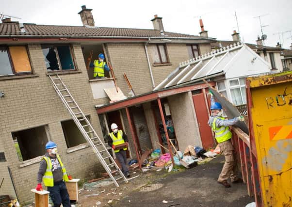 Contractors move in to start renovating the once derelict flats at the entrance to Dunclug Gardens in Ballymena late last year. (Submitted Picture)