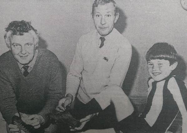 Jonathan McClay was top scorer in the Carrickfergus area junior shield final in June 1985. Highlighting boots that helped to do the damage are teachers Mark McIlroy (left) and Maurice McFarland.  INCT 23-750-CON