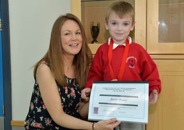 Jason Brown smiles for the camera with his certificate of achievment and Laura Killough at Roddensvale School annual prizegiving. INLT 23-004-PSB