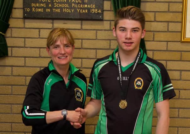 St Patrick's College pupil Thomas Johnston is congratulated by his PE teacher Pauline Thom after winning the Ulster schools senior high jump title at the Antrim Forum recently.