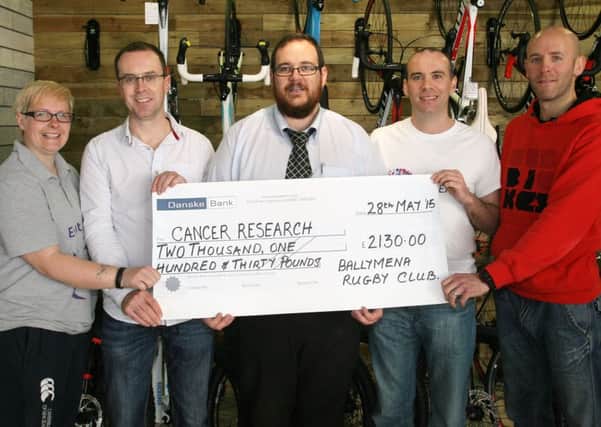 Cormic McWilliams and Alan Reynolds, of Ballymena RFC, are pictured presenting a cheque for £2130 to Lisa Kirkwood and Mark McMahon of Cancer Reasearch, money raised from a recent sponsored cycle. Included is Chris Fairfield of Velo Culture Bike Shop who sponsored the event. INBT23-226AC