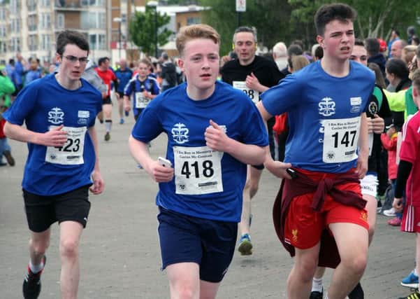 Competitors sprint for the finishing line in the Caolan McCrossan 5K race.