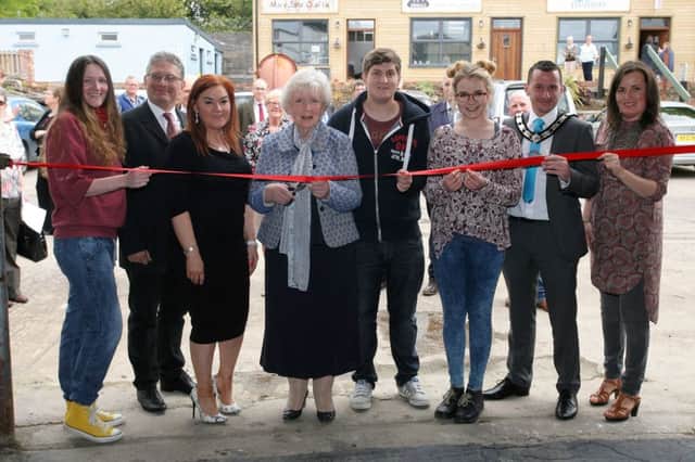 Lord Lt. for County Antrim, Joan Christie, cuts a ribbon to officially open the new community art gallery at Raceview Mill, along with Deputy Mayor of Mid and East Antrim council, Cllr. Timothy Gaston, Anne Donaghy (council Chief Executive), Roy McKeown, Rosalind Lowry (council arts officer) and some of the young artists. INBT24-202AC