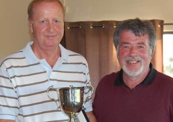 Gary McCullough is presented with the McDowell Cup by Jimmy Hamill.