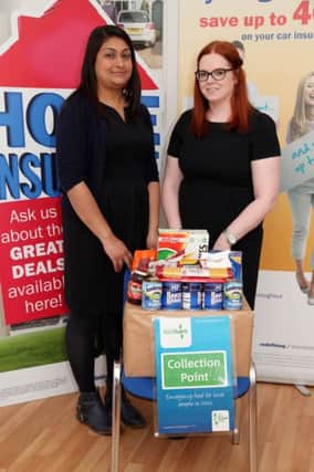 Sundeep Kaur and Michelle McLaughlin of AXA Direct Insurance in Coleraine with some of the items collected for the Causeway Foodbank as part of the AXA Corporate Responsibility Week. INCR24-335PL