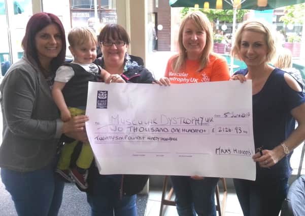 Cathryn Gibson from Muscular Dystrophy UK (second from right) receives a cheque for £2,126 from little Max Thompson, his aunt Stacy Millar, his mum Nikki Thompson and his aunt Terri Broadhurst. INNT 24-542CON