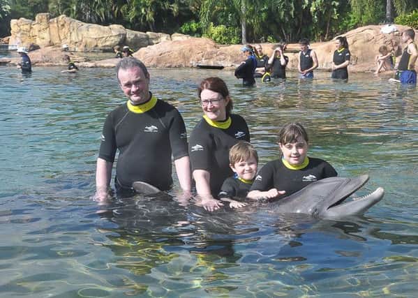 Niamh Mullen with her family and Dixie the Dolphin