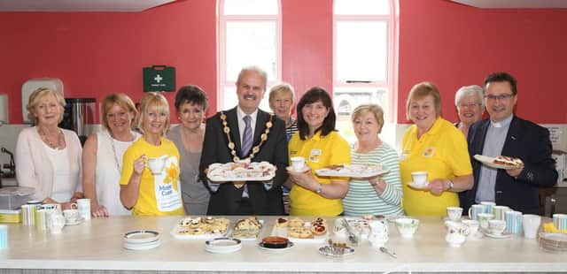 Mayor Thomas Beckett and Rev Paul Dundas, rector of Christ Church, pictured with ladies who held a coffee morning at the church to help raise funds for Marie Curie. US1523-550cd  Picture: Cliff Donaldson