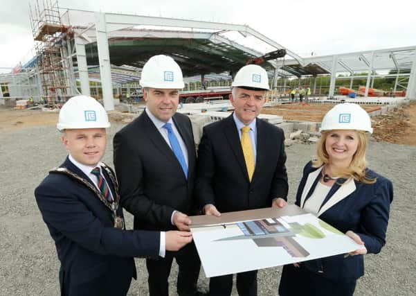 DETI Minister Jonathan Bell with Alastair Hamilton, chief executive of Invest NI, Sarah Holt, RLC, and Mayor of Antrim and Newtownabbey, Cllr Thomas Hogg at the construction site at Global Point. INNT 24-557CON Pic by Kelvin Boyes, Press Eye