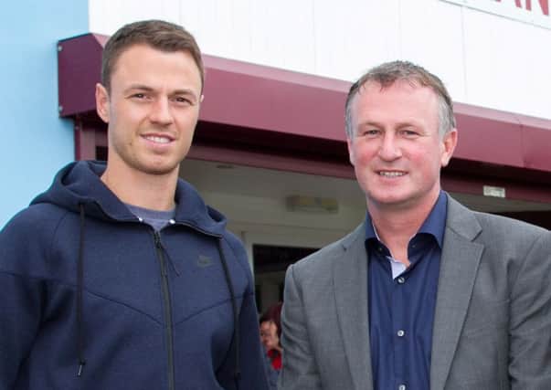 Jonny Evans with Northern Ireland manager Michael O'Neill pictured at Greenisland FC in 2013.