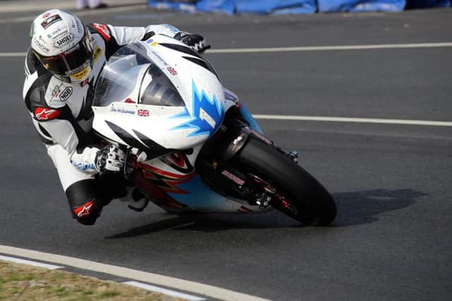 Team Mugen rider John McGuinness set a new lap record for electric bikes to claim his 22nd TT win and move within four victories of Joey Dunlop's record