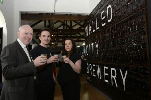 Pictured at the official opening of the Walled City Brewery at Ebrington Square on Friday were, from left, Philip Flynn, Chair of ILEX, James and Louise Huey, proprietors. INLS2415-131KM