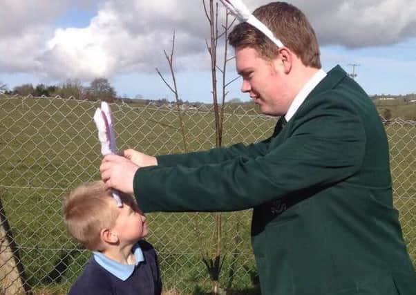 Ronan Hughes has fun with a young pupil of St Joseph's PS in Galbally