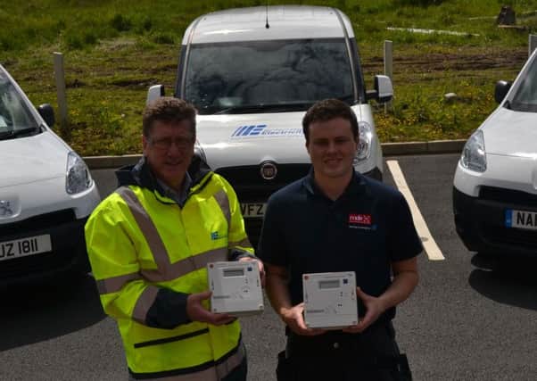 Kyle Stewart from MDE Contractors with NIEs David Bell at the launch of the meter replacement project.  Contractors MDE will replace meters in Carrickfergus over the next two years.  INCT 23-724-CON