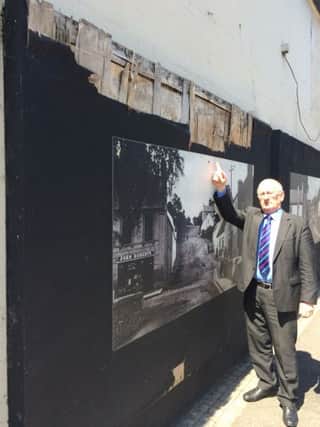 Sydney Anderson MLA at the Gilford murals, which are badly in need of repair.