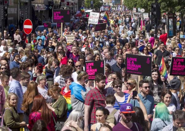 Campaigners attend a rally in Belfast to show their support for marriage equality