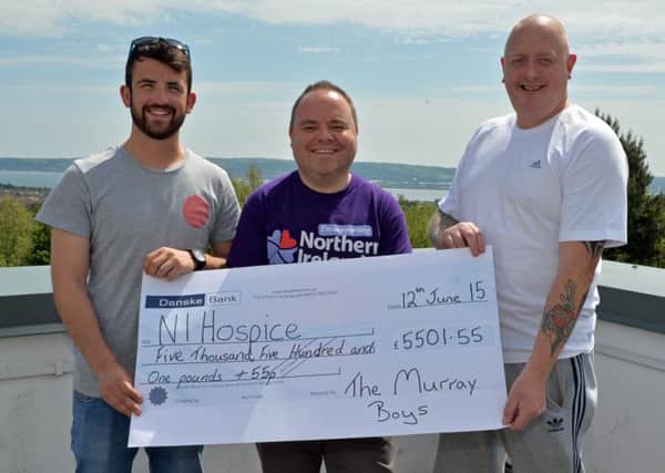 David (right) and Darren (left) Murray from Whiteabbey, present a cheque for £5,501.55 to John Phillips, community fundraiser with NI Hospice. INNT 24-002-PSB