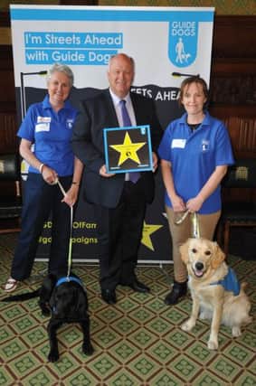 David Simpson MP collecting his star on the Guide Dogs' Walk of Fame.