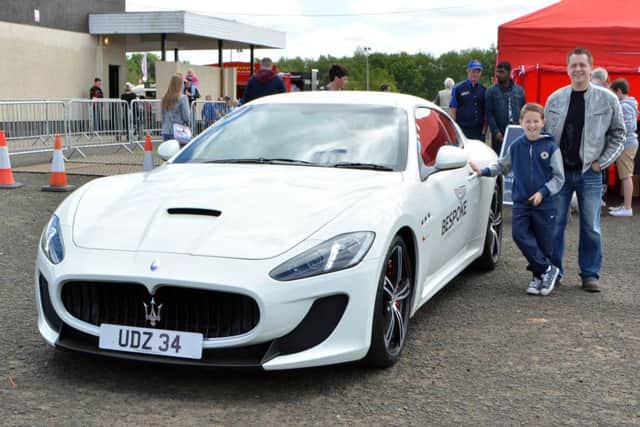Reece Kernohan along with his father, who won a drive in a Maserati at the Ballymena carfest.