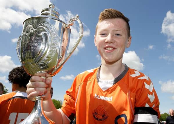 Lisburn Youth captain Leighton Jameson holds up the U13 Cup. US1519-521cd  Picture: Cliff Donaldson