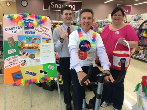 Geoff Purcell Store Manager Ballymoney (on the bike), and behind him Andrew Archibald and Michelle Mc Conville.  inbm26-15s