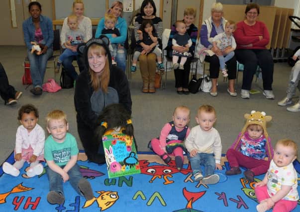 Heather Millar, Carrickfergus Library assistant, with children at the National Bookstart event. INCT 23-219-AM