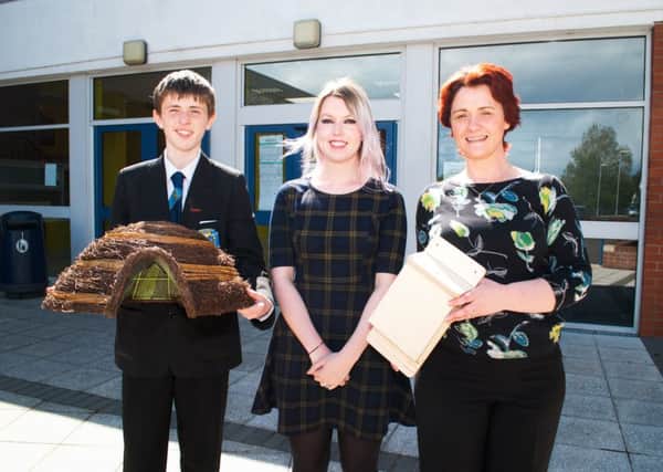Alison Diver from Mid and East Antrim Borough Council receives hedgehog homes and bat boxes from Marc Cummings and Mrs MacQuarrie. INCT 24-721-CON