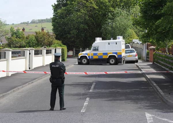 PSNI officers pictured at the scene in Eglinton after the home of PSNI officers was targeted when a bomb was left under a car. DER2415MC056