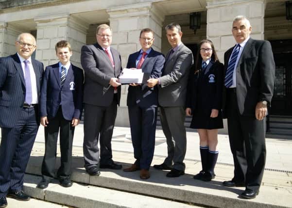 MLAs Jonathan Craig and Edwin Poots with representatives of the school hand over petition to the speaker of the Assembly