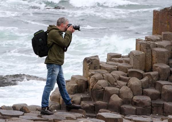 19 June: REPRO FREE  - A popular Dutch Blogger and Instagramer, Eelco Roos, visited Northern Ireland as a guest of Tourism Ireland. He was here to capture lots of great photos and share them on Instagram and Twitter and through a blog posted on Dutch airline, KLMs online account. Pictured here is Eelco capturing the view at the Giants Causeway to share with his online followers. Pic by Paul Nash (repro free). Further media information: Elaine Moore/Clair Balmer, Tourism Ireland Tel: 07766 527719