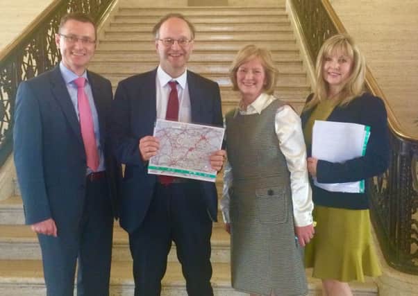 (l-r)Ian McConaghy (Dromore High Principal), Peter Weir MLA (Chair of Stormont Education Committee), Linda Allen (Dromore Central PS) and Brenda Hale MLA holding a map of Dromore showing approved residential development new builds for the Dromore area.