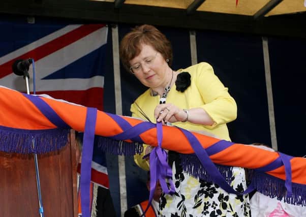 Fiona McCord cuts a ribbon to unveil the new banner for Moyasset True Blue LOL 531. INBT26-220AC