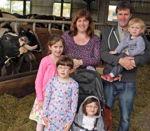 CHEEKY COW. It looks like a cow has 'photo bombed' this pic of Arthur and Amanda Hanna with Naomi, Aimee, Abagail and William at Skeltons' Farm on Sunday.INBM26-15 002SC