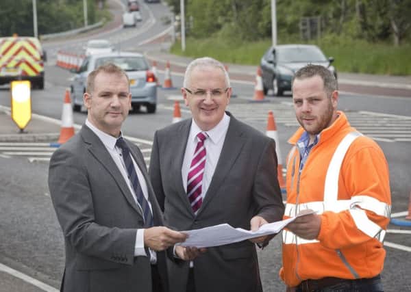 Transport Minister Danny Kennedy with Simon Muldrew, site agend for contractor, Gibson of Banbridge and David Grills of Transport NI.