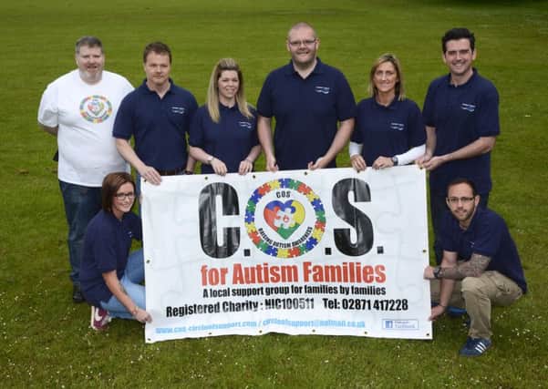 Paddy Harkin, left, committee member of COS (Circle of Support for Autism), pictured with staff of Northern Ireland Water, Gelvin Grange, from left, front row, Edele Doherty and Richard McClelland, back row, Adrian Hurst, Jennifer Doherty, Declan Mellon, Kellie Deery and Leslie Smyth, who will be taking part in the Mournes 7 Seven Challenge on the 1st of August to raise funds for the charity. INLS2515-196KM